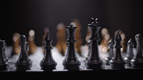 Silver-chess-pieces-lined-up-and-ready-for-battle---shallow-focus-trucking-shot