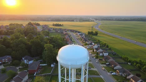 Aerial-view-rising-over-the-watertower-in-Clarksville-revealing-a-beautiful-sunrise-at-the-end