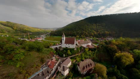 Beautiful-FPV-shot-of-the-painterly-Kremstal-landscape,-showing-the-church-and-ruin-of-Senftenberg