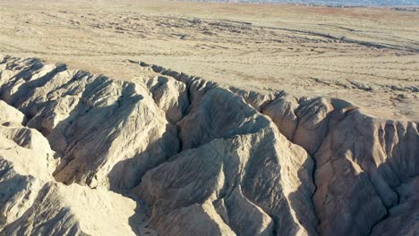 Aerial-Flying-Over-Hills-in-Desert-on-Hot-Dry-Day---Arroyo-Tapiado-Mud-Caves-in-Anza-Borrego-State-Park