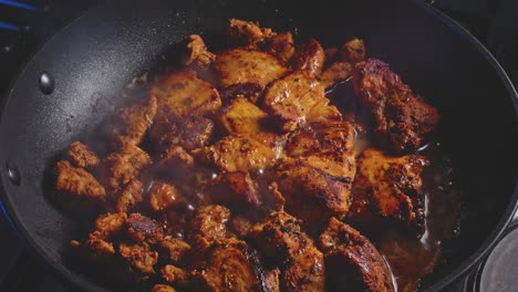 Pouring-Water-Into-Fried-Chicken-Breast-In-A-Pan,-Cover-And-Let-It-Simmer