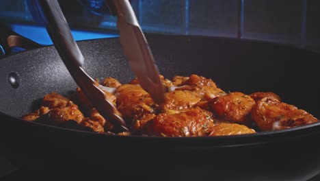 Cooking-And-Flipping-Spicy-Marinated-Chicken-Breast-In-A-Pan-Using-Tongs