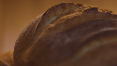 Close-up-of-the-crust-of-a-golden-bun,-macro-slow-motion-shot