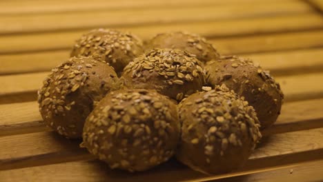 Bun-balls-covered-with-sesame-seeds-baked-in-the-oven-are-displayed-on-the-wooden-shelf