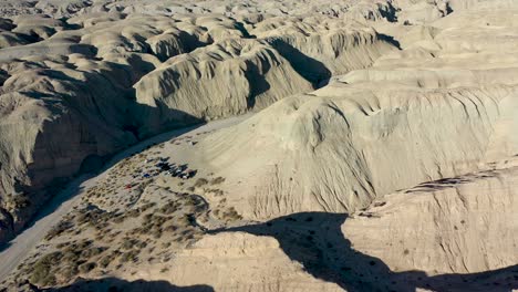 Aerial-Flying-Over-Explorer's-Campsite-in-Desert-on-Hot-Dry-Day---Arroyo-Tapiado-Mud-Caves-in-Anza-Borrego-State-Park