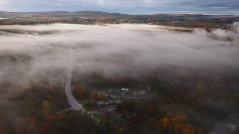 Neighborhood-Covered-In-A-Layer-Of-Fog-During-Autumn-In-Sherbrooke,-Quebec,-Canada---aerial-drone-shot