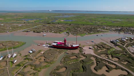 Aerial-view-towards-the-stranded-LV15-Trinity-Lightvessel,-sunny-Tollesbury,-UK---approaching,-drone-shot