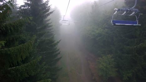 Cable-cars-riding-in-the-hills-of-the-mountains-on-a-cold-foggy-day-in-autumn