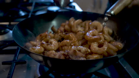Frozen-Prawns-Covered-In-Spices-Being-Heated-And-Stirred-And-Wok-In-Kitchen