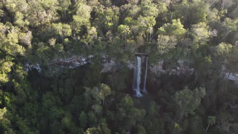 Aerial-orbiting-shot-of-flowing-idyllic-Salto-Arrechea-Fall-in-middle-of-Iguazu-Jungle-during-sunlight---Argentinian-and-Brazilian-Border