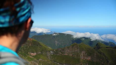 young-red-haired-girl-enjoys-the-panoramic-view-from-the-top-of-the-mountain-in-Madeira-island