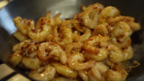 Prawns-Being-Stirred-And-Shaken-Inside-Wok-With-Wooden-Spoon