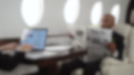 Blurred-background-of-a-wealthy-couple-inside-a-private-jet,-businesspeople-traveling-in-airplane