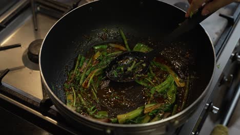 Pak-Choi-And-Chilli-Paste-Being-Stirred-In-Oil-Inside-Wok