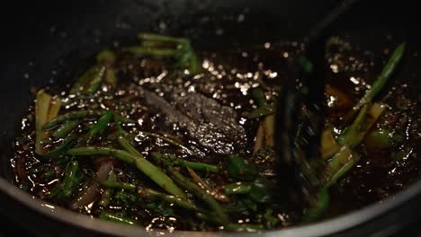 Pak-Choi-And-Chilli-Paste-Being-Stirred-In-Oil-Inside-Wok
