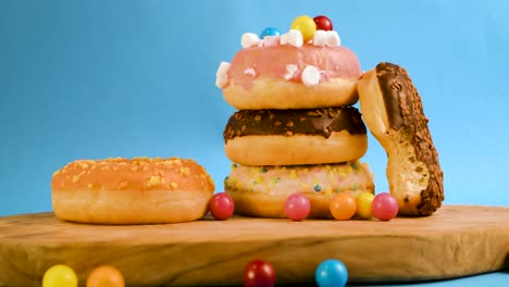 Steady-shot-of-a-pile-of-donuts-with-falling-gumballs