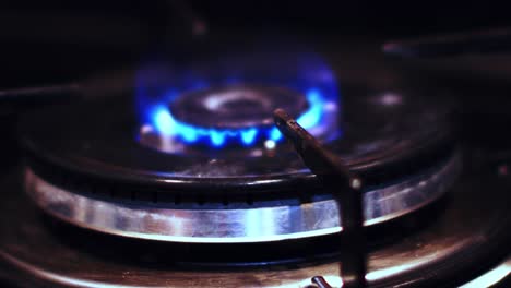 close-up-top-view-of-igniting-a-gas-cooker-with-a-bright-blue-flame