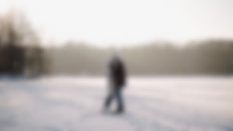 Romantic-couple-kissing-in-the-woods-with-a-winter-landscape-background-during-christmas-season