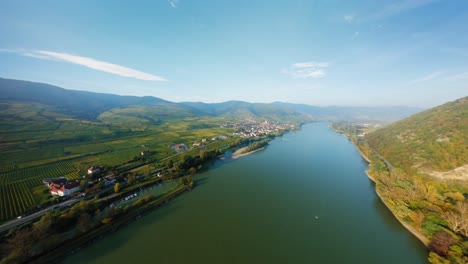 Slow-aerial-shot-of-the-river-Danube,-market-town-Spitz,-and-the-surrounding-nature