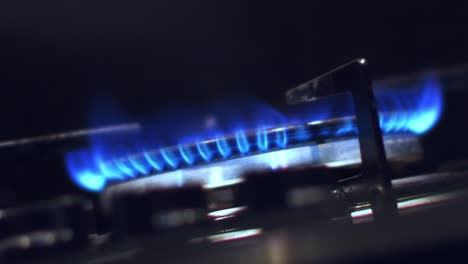 close-up-viewed-from-below-of-igniting-a-gas-cooker-with-a-bright-blue-flame