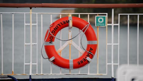 Orange-lifebuoy-of-the-Aratere-ferry-traveling-from-Wellington-to-Picton-in-New-Zealand