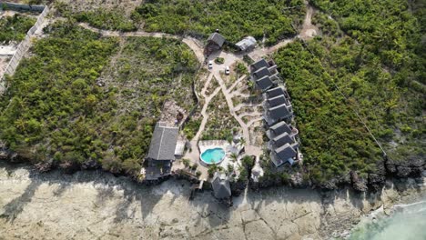 Kusini-beach-bungalow-resort-with-pool-in-East-Zanzibar-Island-Tanzania-Africa,-Aerial-top-view-shot