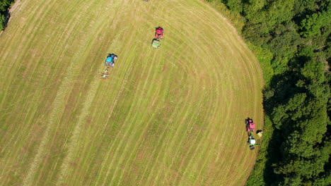 Top-View-Of-Working-Tractors-Riding-On-Fields-In-Summertime