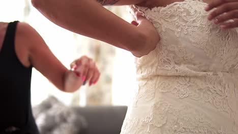 Slow-motion-close-up-handheld-shot-of-a-bride-in-white-wedding-dress-getting-ready-for-her-wedding-with-her-husband-to-be-on-her-wedding-day