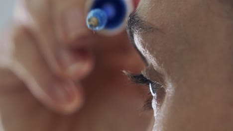 Extreme-close-up-of-focused-pretty-woman-applying-light-dye-to-eyebrows-with-makeup-brush