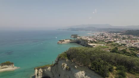 Aerial-view-of-the-tourist-town-Sidari-on-the-island-Corfu,-cliffs-along-the-coast-of-the-turquoise-sea