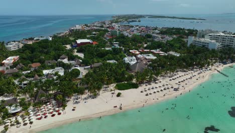Aerial-view-over-the-Playa-Norte-beach-and-the-village-of-Isla-Mujeres-island-in-sunny-Mexico---rising,-drone-shot