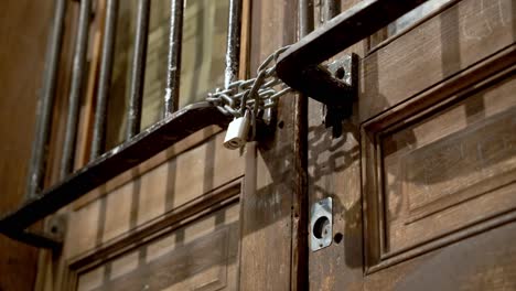 Closeup-of-a-locked-wooden-door-at-night