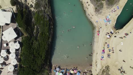 Top-down-aerial-over-Canal-d'Amour---swimming-tourists,-Sidari,-Corfu,-Greece