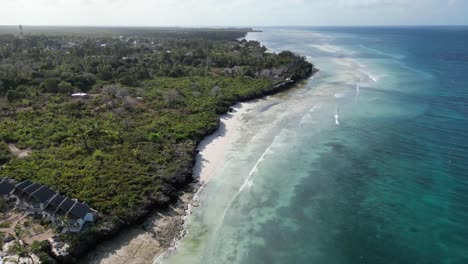 Kusini-beach-bungalow-resort-in-East-Zanzibar-Island-Tanzania-Africa,-Aerial-flyover-shot