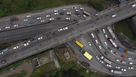 Cinematic-top-down-aerial-view-of-beautiful-expressway-interchange-with-cars-and-heavy-transportation-vehicles-crossing-each-other