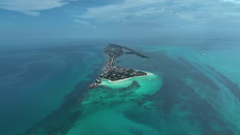 Aerial-view-overlooking-the-Isla-Mujeres-island-in-sunny-Mexico---high-altitude,-orbit,-drone-shot