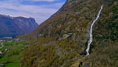 Aerial-drone-forward-moving-shot-of-majestic-mountains-with-Kjelfossen-waterfall-near-Gudvangen-Village,-Aurland-Municipality,-Vestland-County,-Norway-at-daytime