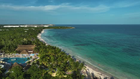 Aerial-view-overlookinga-exotic-beach-in-Xpu-Ha,-Mexico---static,-drone-shot