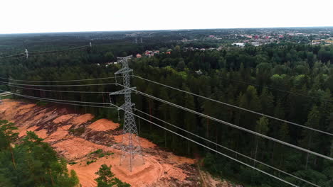 Aerial-drone-pan-shot-from-left-to-right-over-newly-installed-electric-pole-surrounded-by-dense-forest-on-a-cloudy-day