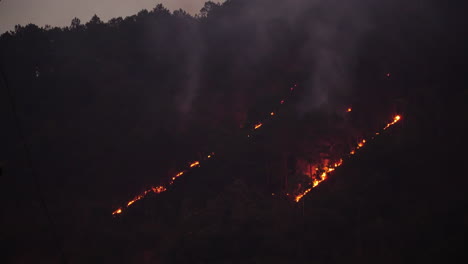 Wildfire-in-mountain-vegetation-at-twilight,-Vietnam.-Static