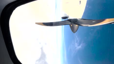 Propeller-airplane-flying-through-the-clouds,-vertical-video