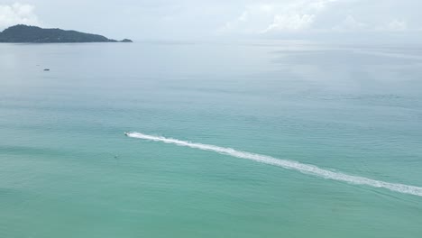 Cinematic-aerial-panoramic-cityscape-landscape-view-of-Jet-Ski-on-Patong-Beach-in-Phuket,-Thailand