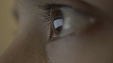 A-super-extreme-close-up-of-a-female-human-eye-reflecting-a-desktop-screen-while-doomscrolling-or-doomsurfing-on-the-web-putting-unhealthy-strain-on-the-eyes
