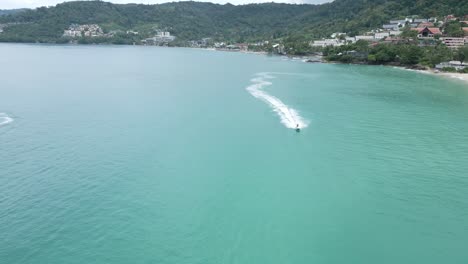 Cinematic-aerial-panoramic-cityscape-landscape-view-of-Jet-Ski-on-Patong-Beach-in-Phuket,-Thailand