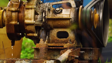 close-up-of-mechanical-water-pump-used-for-watering-land-field-farm-irrigation-in-remote-rural-area-of-Vietnam
