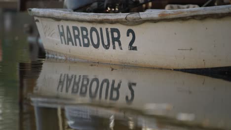 Docked-small-emergency-row-boat-with-harbour-number-2-printed-on-side