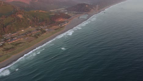 Aerial-shot-panning-down-over-the-ocean-and-Oregon-coastline