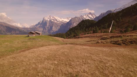 aerial-drone-footage-pushing-in-over-alpine-meadows-revealing-views-of-Wetterhorn-in-the-Swiss-Alps