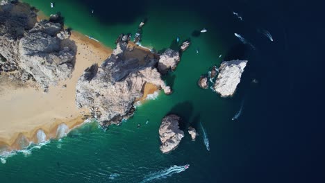 Aerial-view-above-the-rocky-arch-of-Cabo-San-Lucas,-sunny-Mexico---top-down,-drone-shot