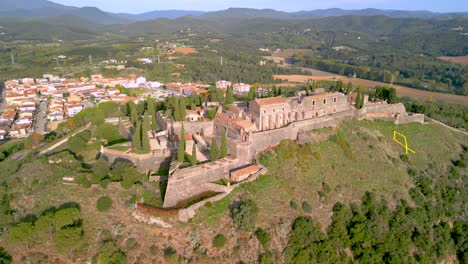 Hostalric-aerial-images-medieval-town-in-Catalonia-touristic-castle-on-top-of-the-mountain-Hostalric-Castle-is-a-military-fortification-Closeup-of-laz-or-yellow-independence-symbol